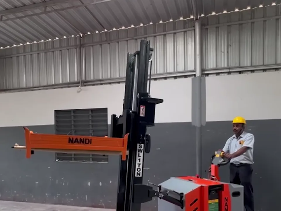 Battery-operated counterbalanced stacker with raised mast on the Nandi Equipments shop floor in Coimbatore